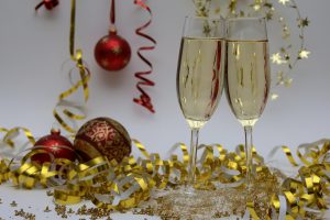 celebrate: two champagne glasses with confetti surrounding it