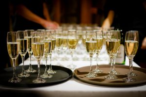 champagne glasses on trays on a white table cloth