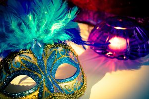 Mardi Gras mask with greens, blues, purbles, and yellow