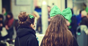 St. Patrick's Day: two girls with a green bow and green four-leaf clover